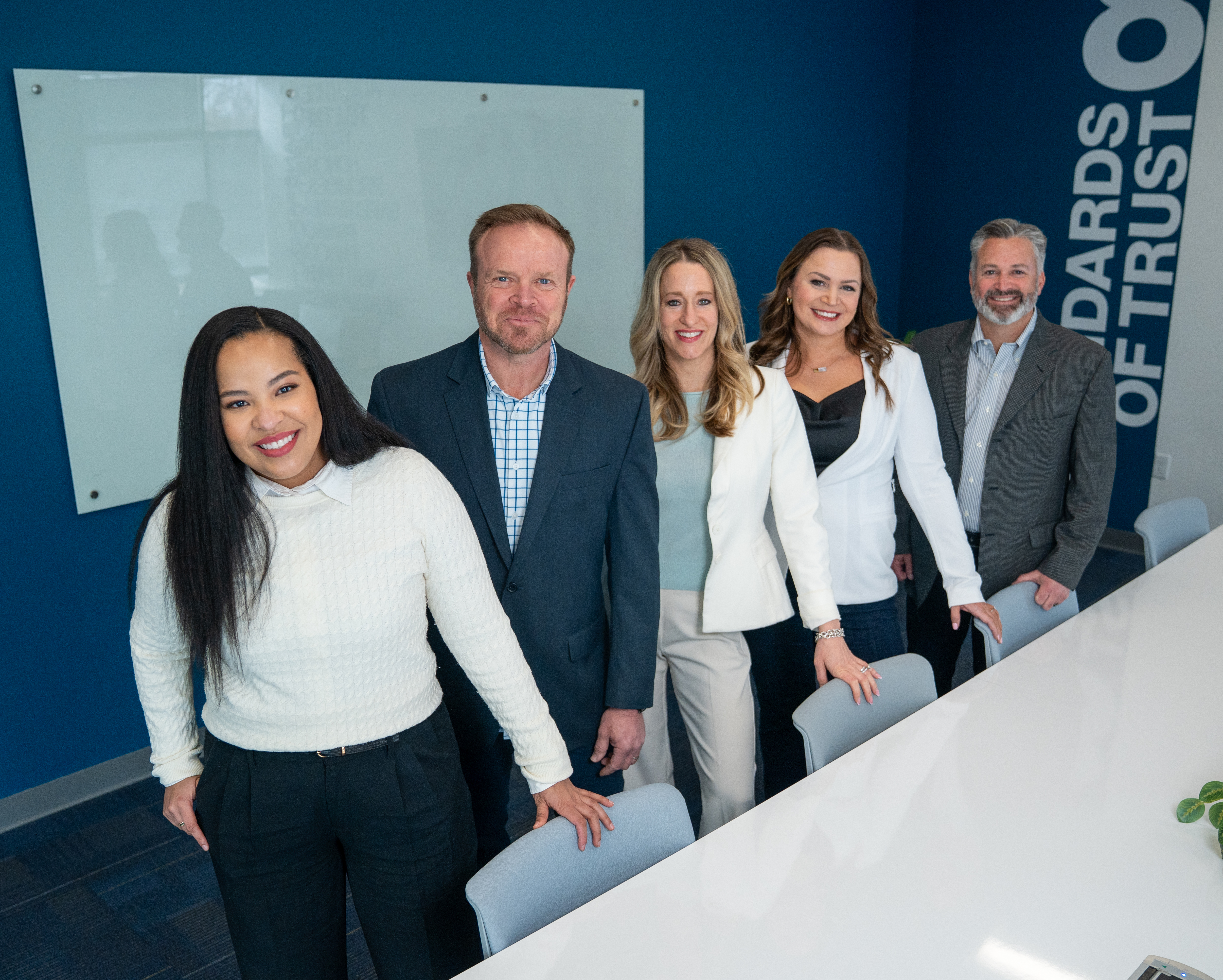 Exec team standing together.